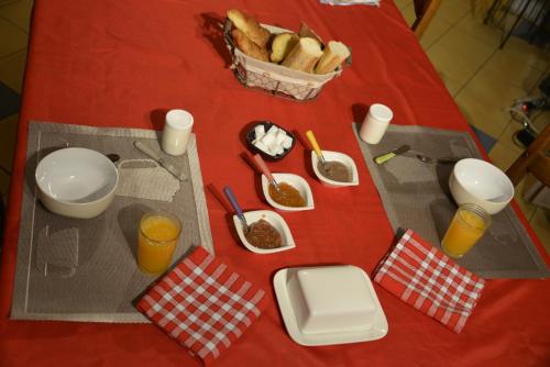 a red table with food and drinks on it at Couloumine Breizh in Saint-Aignan