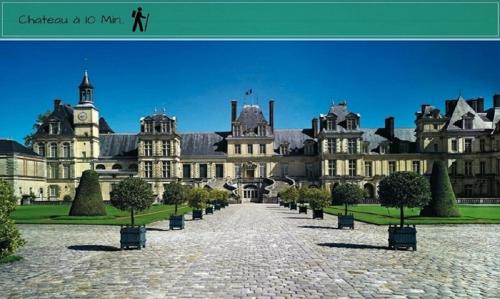 a large building with a pathway in front of it at Centre Ville Chateau in Fontainebleau