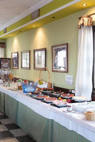 a buffet line with food on a table at Hotel y Bungalows Balcón de Competa in Cómpeta