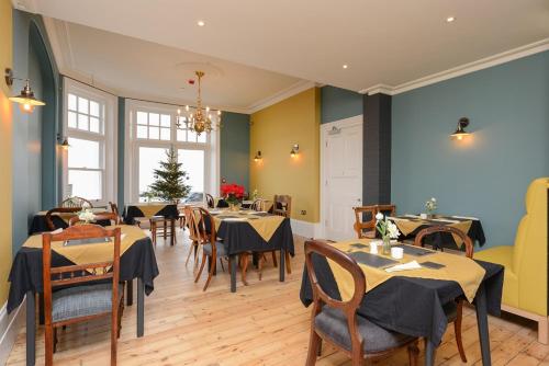 a restaurant with tables and chairs in a room at Bay Tree Broadstairs in Broadstairs