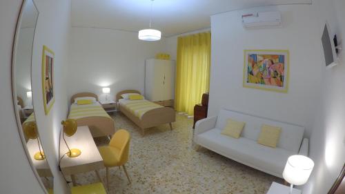 a living room with two beds and a couch at smArt B&B in Salerno