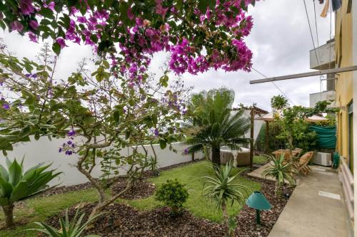 a garden with purple flowers in a building at epicenter LAGOA in Lagoa