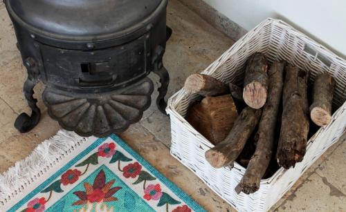a basket filled with logs next to a trash can at Point of View in Bruchim Qela' Alon