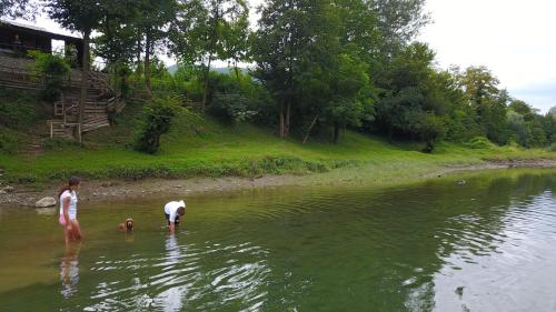 two people and a child standing in the water at Kucerak na Drini in Bajina Bašta