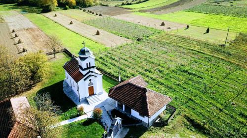 an aerial view of a small white church in a field at Kucerak na Drini in Bajina Bašta