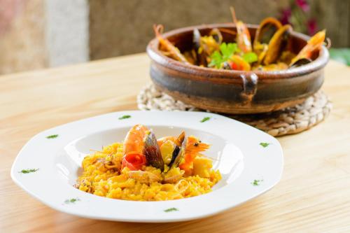 a plate of food on a table with a bowl of food at Pazo de Mendoza in Baiona