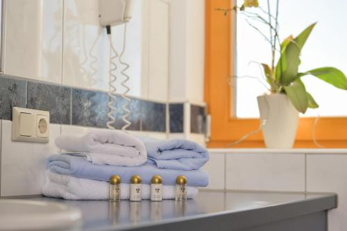 a pile of towels on a counter in a bathroom at Wildwiesenhof in Miesenbach