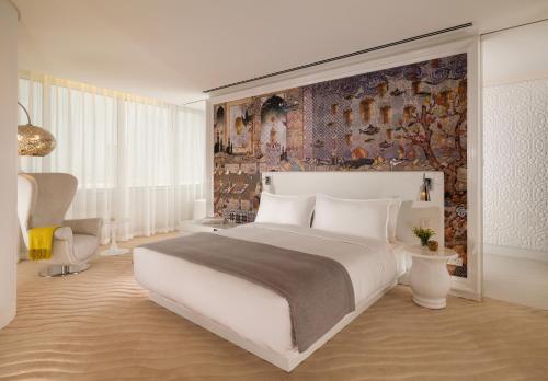 a bedroom with a large white bed and a wall at DELUXE APARTMENTS - free parking in Drama