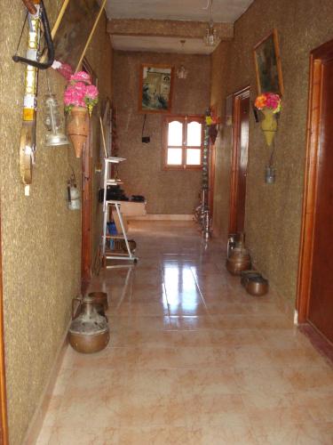 a large room with pots on the walls and a floor at Auberge Gitelkst in Tafraoute