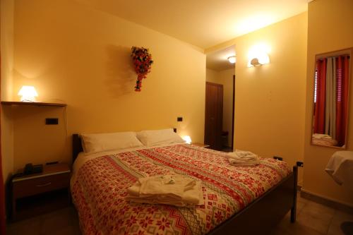 a bedroom with a bed with a red bedspread at Da Cecilia in Bognanco