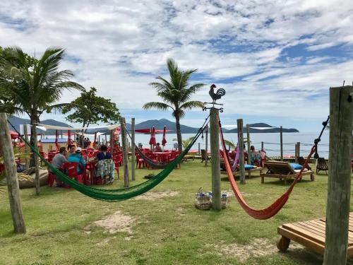 a playground with a hammock and a pirate ship at Pousada Tia Cleide in Caraguatatuba