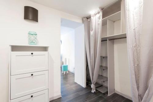 - une chambre avec des placards blancs et un dressing dans l'établissement Appartement le St Roch, à Montpellier
