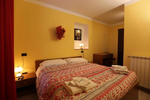 a bedroom with a bed with two towels on it at Da Cecilia in Bognanco