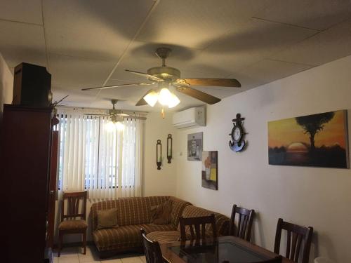 a living room with a ceiling fan and a couch at NUESTRA CASA-OUR HOME Salinas by A2CC in Salinas