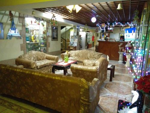 a living room with two couches and a table at Hotel Panamericano in Lima
