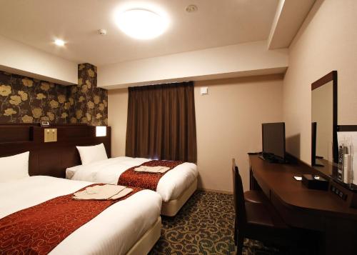 Tempat tidur dalam kamar di Hotel. Links Namba