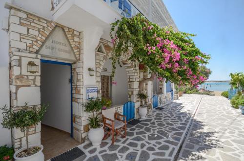 a street in positano with flowers on a building at Saint George Hotel in Naxos Chora