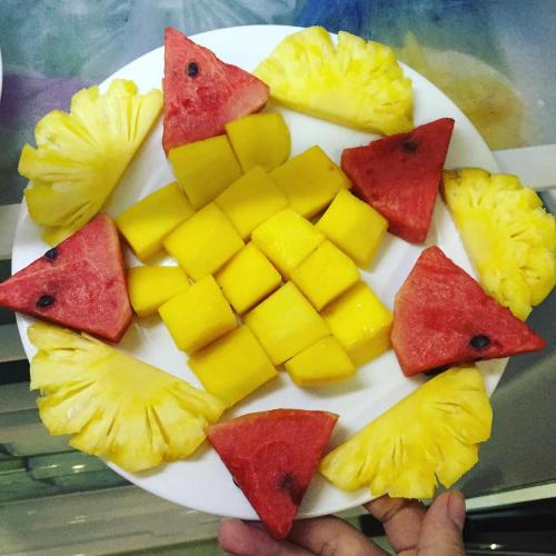 a plate full of fruit on a table at Hue Homestay Riverside in Hue
