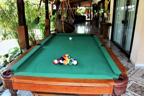 a pool table with a pile of pool balls on it at Mansão Dubai in Santa Cruz Cabrália