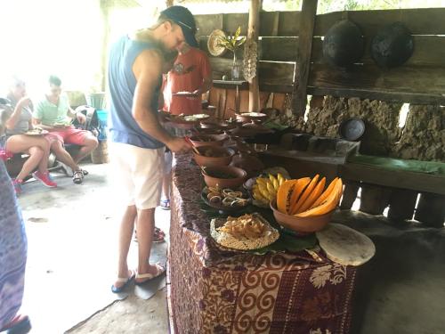 a man standing in front of a table with food at Yapahuwa Relax Stay in Yapahuwa