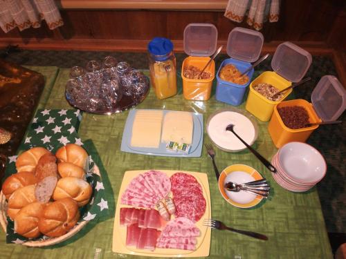 a table topped with different types of meats and food at Hoazhof in Kals am Großglockner