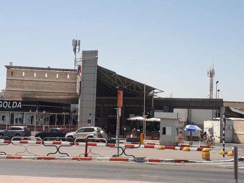 a large building with cars parked in front of it at Apartment 2 bedrooms Central Location in Ashdod