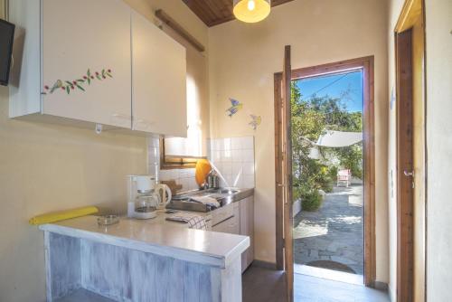a kitchen with a sink and a counter top at Harry's Studios 1 in Gaios