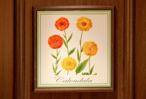 a framed picture of flowers with the word calendula at Monastero Santa Rosa Hotel & Spa in Conca dei Marini