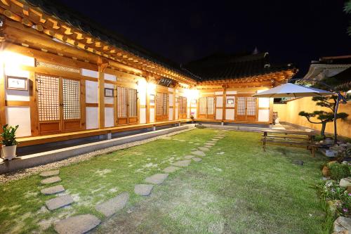 a courtyard of an asian house at night at Hanok Hyeyum in Jeonju