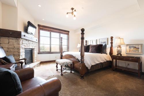 a bedroom with a large bed and a fireplace at Silver Star #1205 - 3 Bed Condo in Park City