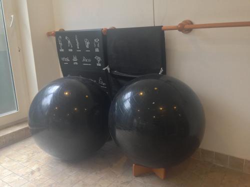 two large black balls sitting next to a wall at Felix Alley in Ho Chi Minh City