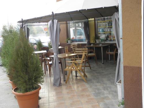 a restaurant with tables and chairs under a tent at Hotel Pilevski in Blagoevgrad