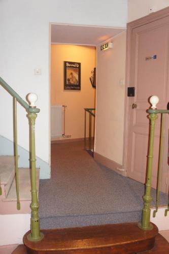 a hallway with a staircase and a stair case at The Old Hotel Ravel Centre in Clermont-Ferrand