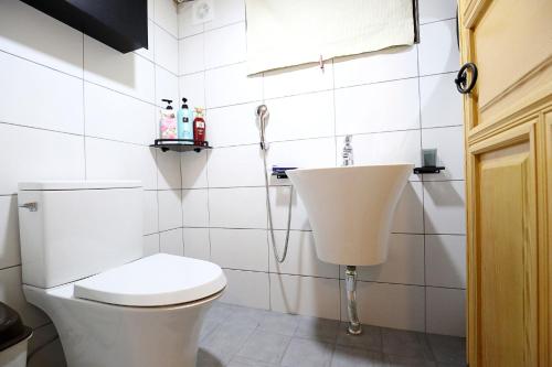 a bathroom with a toilet and a sink at Hanok Hyeyum in Jeonju