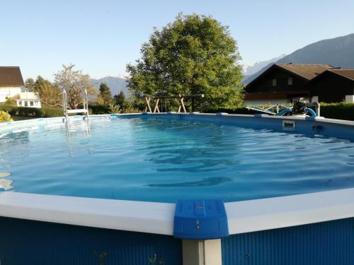 a large swimming pool with blue water at Ferienwohnung Albert Egger in Nötsch