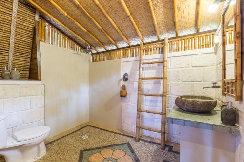 a bathroom with a sink and a toilet at Milo's Home in Jimbaran