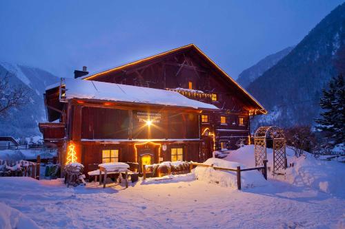 a log cabin in the snow at night at Ferienhaus Knor in Umhausen