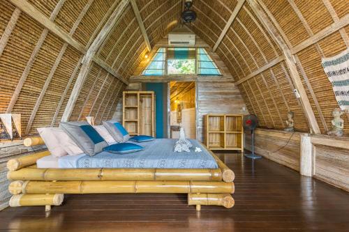 a bedroom with a large bed in a building at Milo's Home in Jimbaran
