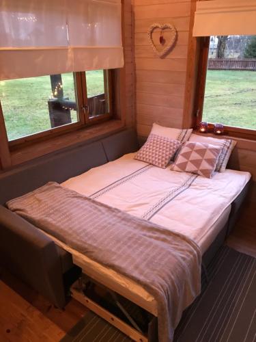 a bed in a room with a window at Laasi Cozy Cottage in Kaigutsi