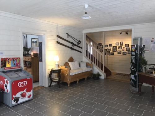 a living room with a couch and a stair case at Norrsjön in Sörsjön