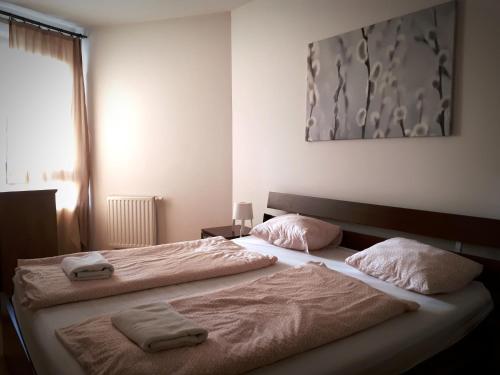 a bedroom with two beds with towels on them at Gozsdu Suite Apartment in Budapest