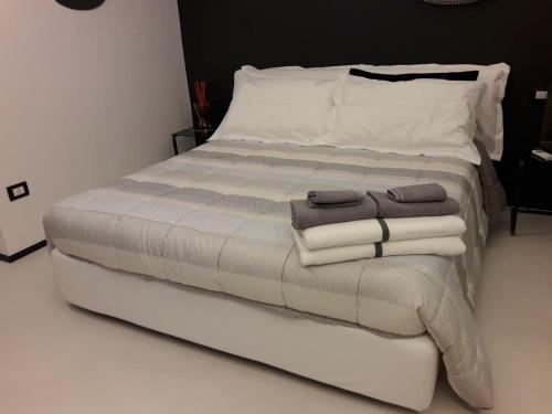 a bedroom with a bed with towels on it at Ananke B&B in Bisceglie