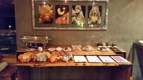 a table with a bunch of food on it at Hotel Altiplanico Puerto Natales in Puerto Natales