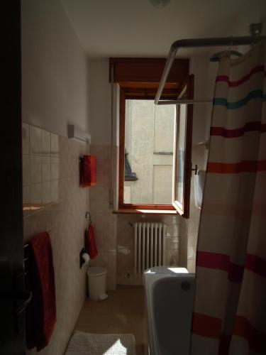 a bathroom with a shower and a toilet and a window at Giuly Home in Caspoggio