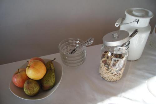 a table with a plate of fruit and a jar of food at Biohof Ebenbauer in Waidhofen an der Ybbs
