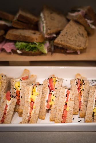 a group of sandwiches on a white plate at Hotel Villa Rosa Riviera in Rimini