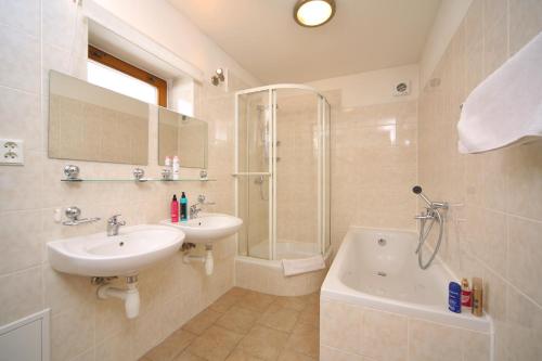 a bathroom with a sink and a shower and a tub at Villa 6 Vrchlabí in Vrchlabí