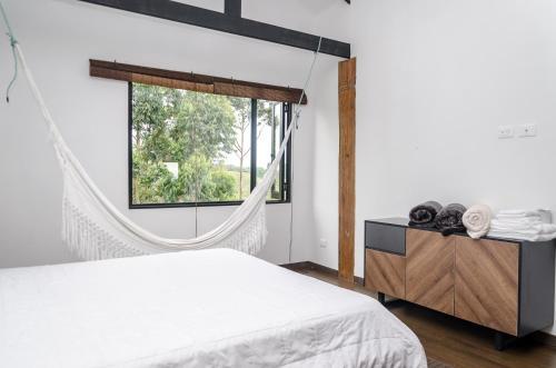 a bedroom with a bed and a window at Casa Bambuco Filandia in Filandia
