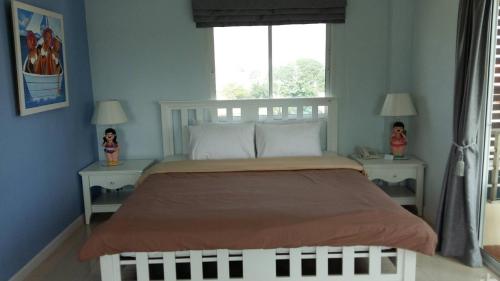 a bedroom with a large bed with two night stands at Baanchomchan in Hua Hin