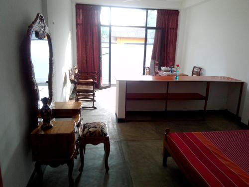 a living room with a dressing table and a mirror at Villa Maleena in Hikkaduwa